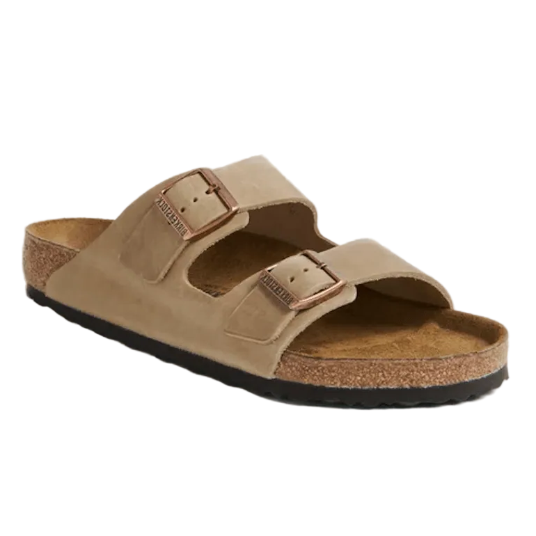 A single Birkenstock Arizona double-strap slide sandal in tan suede, featuring a cork footbed, adjustable buckles, and a black outsole, shown on a white background.