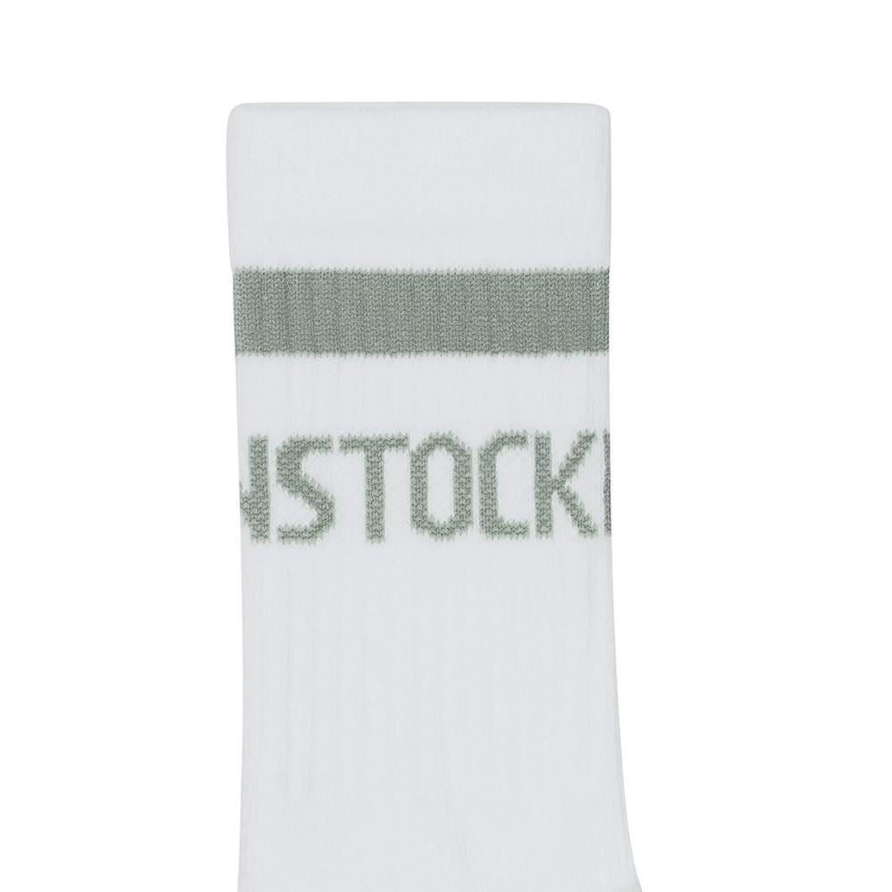 White sock with green band and 'Socke' branding on a white background